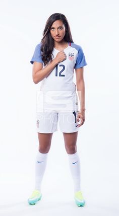 a female soccer player is posing for a photo with her hands clasped to her chest