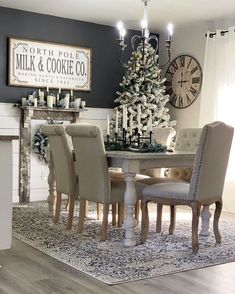 a dining room table with chairs and a christmas tree