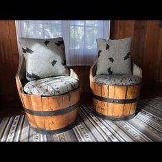 two wooden barrel chairs sitting next to each other