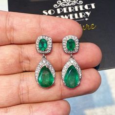 ONE OF A KIND HANDCRAFTED EARRINGS. IN STOCK! READY FOR SHIPPING! GIFT WRAP AVAILABLE! FREE UPS EXPRESS! DANGLING! GET THE PERFECT PIECE OF JEWELRY AS A CHRISTMAS GIFT FOR YOUR LOVED ONE! STUNNING 10.65TCW, Certified Zambian Emerald earrings. UNIQUE DESIGN! ONE OF A KIND! TRANSPARENT, SPARKLING EMERALDS IN PAIR! Extremely rare! Surrounded by TOP GRADE, F/VS DIAMONDS! Set in 18K solid white gold earrings. Our jewelry are specially designed, and are delicately handcrafted by local Thai, profession White Gold Christmas, Emerald Diamond Earrings, White Gold Earrings Studs, Christmas Handmade, Zambian Emerald, Vs Diamond, Gold Chandelier, White Gold Earrings, Earrings Unique