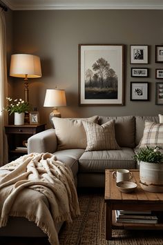 a living room with a couch, coffee table and pictures on the wall above it