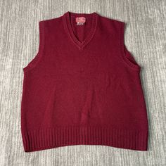 Vintage 80s Northwestern Knitting Company Basic Blank Dress Formal Casual Wool Material Grandpa Fashion Maroon Knit Sweater Vest Large Mens Condition:  Excellent Used Condition  = No Flaws Measurements: Please see photos above for all measurements IF YOU BUY TWO OR MORE ITEMS USE THE CODE BUNDLE @ CHECK TO SAVE 20% WE SHIP WITHIN 24 HOURS AFTER PURCHASE! Please be aware that we do not offer free returns!! The Buyer is responsible for the cost of the return label.  Follow us on TikTok & Instagram @findsnostalgic and tag us in your finds Retro Crew Neck Sweater Vest For Fall, Retro Sleeveless Sweater For Winter, Vintage Sleeveless Sweater For Winter, Retro Knit Sweater Vest For Winter, Retro Knitted Sweater Vest For Winter, Retro Knit Sweater Vest For Fall, Casual Sleeveless Wool Sweater, Casual Fitted Wool Sweater Vest, Knitted Wool V-neck Tops