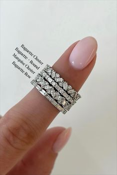 a woman's hand with three rings on top of her finger and the ring has diamonds