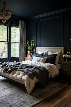 a bedroom with dark blue walls and white bedding in the middle, along with a large rug on the floor