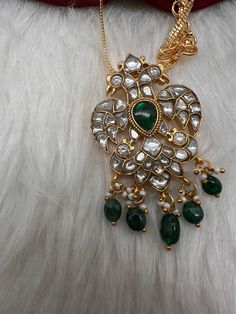 Jadau Kundan Pendent Necklace with matching EarringsColor : GoldenSize : Pendent Length : 2.25 Inches; No Earrings; Chain : 16 InchesStones : Jadau Kundan Pearls Emerald Beads Necklace Traditional, Earrings Chain, Kundan Necklace, Emerald Bead, Pendent Necklace, Durga Goddess, Kundan Necklaces, Social Events, Indian Jewelry