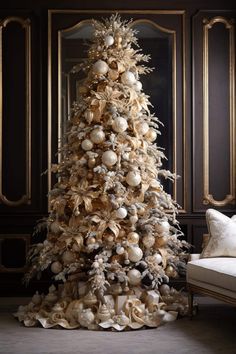 a decorated christmas tree with white and gold ornaments