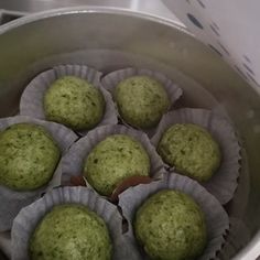 some green muffins are sitting in the middle of a pot on the stove