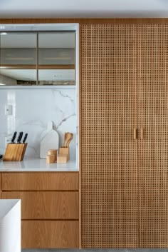 a kitchen with wooden cabinets and white counter tops