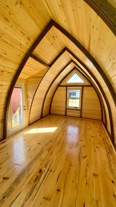 an empty room with wooden floors and walls