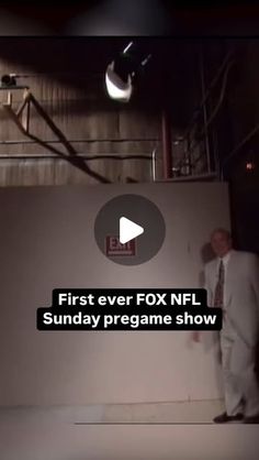 a man in a suit and tie standing next to a wall with the words first ever fox nfl sunday pregame show