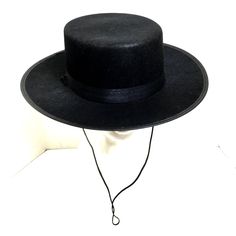 Zorro Classic Black Spanish Hat Zorro’s Hat Is A Signature Part Of His Look Complete Your Costume With Classic Hat Great For Many Costumes Spanish - Gaucho - Amish - Flat Top - Cinco De Mayo - Costume Hats Hat Comes With Chin Ties Black Satin Ribbon Hat Band 100% Polyester One Size Fits Most 23“ Diameter Flat - Wide Brim - 2 ¾” Crown 3.5” Black High Crown Fedora For Winter, Black Boater Hat With Short Brim For Rodeo, Black Boater Hat For Rodeo With Short Brim, Black Top Hat With Flat Brim, Black Adjustable High Crown Fedora, Black High Crown Felt Hat With Adjustable Fit, Black Wide Brim Costume Hat, Black Brimmed Mini Hats For Rodeo, Black Wide Brim Costume Hat For Winter