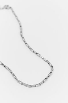 Inspired by the minimalist aesthetic of architectural lines, this necklace is a statement of understated luxury. The design features a series of interlocking rectangular links, reminiscent of classic chain jewelry but with a contemporary twist. The simplicity of its design makes it versatile enough to complement any outfit, from casual daytime looks to more formal evening attire. Also available in Gold. Choose the perfect fit for your style. Cipher necklace is available in 4 lengths - 18, 20, 24 Silver Gold Necklace, Hair Charms, New York Studio, Chain Belts, Understated Luxury, Circle Ring, The Minimalist, Chain Jewelry, Minimalist Aesthetic