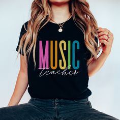 Thank you for checking out my Music Teacher Shirt listing. This music shirt is super soft and comfy. This cute music teacher tshirt is available in black, heather grey, and heather navy. This rainbow music shirt would make a great gift for any music teacher. If you like this listing, please visit my shop. I'm a full time band teacher that sells laser items, apparel, and ornaments. teamfreitas.etsy.com Music Teacher Shirt Rainbow Cute Music Teacher Tshirt Elementary Music Teacher Tee Music Educator Shirt Gift for Music Teacher Appreciation Black Relaxed Fit Music-themed T-shirt, Black Music-themed Top With Letter Print, Black Music-themed T-shirt With Letter Print, Black Music-themed T-shirt With Text Print, Music Teacher Shirts, Music-themed Pre-shrunk Black T-shirt, Black Pre-shrunk Music-themed T-shirt, Black Text Print T-shirt For Music Festival, Music Teacher Shirt