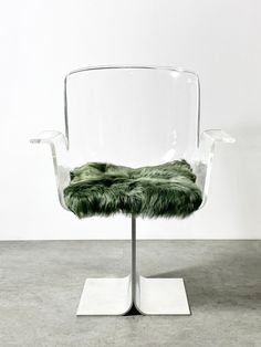 a clear chair with green fur on it