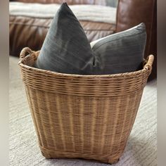 two pillows in a wicker basket on the floor