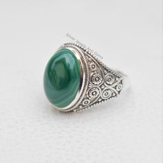 Gemstone-Malachite Shape-Oval Stone Size- 10x14 MM Metal-925 Sterling Silver This One of a kind ring is adorned with beautiful rich green color Malachite Gemstone set in sterling silver band. Malachite is the birthstone associated with the Scorpio,zodiac sign About gemstone- Malachite is vibrant green color stone which can bring transformation by assisting one in changing situations..The green color of this stone is the color of abundance of spirit and prosperity.Malachite act as guardian of the Green Oval Rings With Natural Stones, Handmade Green Oval Cabochon Ring, Green Sterling Silver Oval Rings, Green Oval Sterling Silver Rings, Oval Emerald Ring With Natural Stones In Sterling Silver, Silver Malachite Gemstone Ring, Oval Malachite Gemstone Jewelry, Silver Malachite Rings As Gift, Handmade Silver Malachite Rings