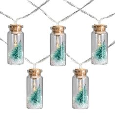 christmas lights in glass jars with pine trees inside