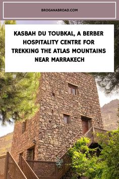 a stone building surrounded by trees with the words kasba du toubka, a