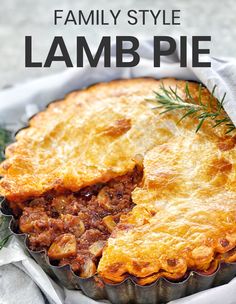 a pie with meat and vegetables in it on top of a table next to a napkin