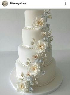 there is a wedding cake with white flowers on it