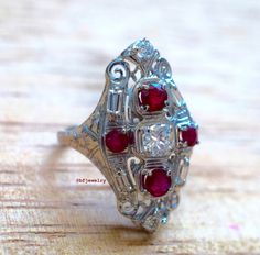 Art Deco Style Diamond And Ruby Ring by BFJewelryEst1984 on Etsy Elegant Multi-stone Rectangular Rings, Elegant Rectangular Multi-stone Rings, Luxury Silver Ruby Ring With Baguette Cut, Art Deco Ruby Ring With Diamond Cut For Wedding, Luxury Baguette Cut Ruby Ring For Wedding, Luxury Rectangular Ruby Ring For Wedding, Art Deco Oval Ruby Ring For Anniversary, Art Deco White Gold Ruby Ring For Wedding, Art Deco White Gold Ruby Wedding Ring