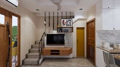 a living room with stairs leading up to the top floor and a flat screen tv