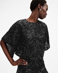 Sparkle all season long. The Ivy Top has a flowing shape that boasts a round neck and delicately draped sleeves. It's relaxed-fitting and cropped to create an elevated structure. Elegant gems, sequins and bead embellishments are a luxe touch. Dress this up with the matching skirt or fitted pants (don't forget a statement metallic heel, now that's a look).  This top is designed to a relaxed fit Keyhole button closure at the back of the neck Round neck Short sleeves Cropped Draped sleeves and heml Elegant Batwing Sleeve Party Tops, Chic Crew Neck Blouse For Evening, Elegant Cropped Sequin Top, Spring Evening Blouse With Batwing Sleeves, Cropped Mesh Top, Black Ivy, Embellished Crop Top, Drape Sleeves, The Ivy