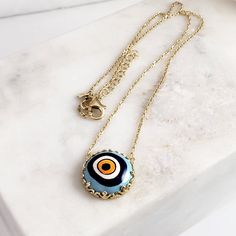 Introducing our stunning Cable Chain with a Hand-Painted 19mm Evil Eye Turkish Pendant in a Decorative Prong Setting. This gold Evil Eye Necklace is the perfect addition to any jewelry collection, with its unique design and intricate detailing. Crafted with care, this necklace features an 18+2 inch chain and a hand-painted Turkish pendant measuring 19mm in size. The evil eye symbol is said to ward off negative energy and bring good luck, making this necklace both beautiful and meaningful. Our Ca Gold-tone Chain Necklace With Round Pendant Gift, Gold-tone Round Pendant Chain Necklace Gift, Handmade Gold Plated Round Pendant Necklace, Handmade Gold-tone Chain Necklace Gift, Handmade Gold Plated Chain Necklace With Round Pendant, Handmade Charm Necklace With Round Gold Plated Pendant, Handmade Gold Plated Charm Necklace With Round Pendant, Gold-tone Amulet Necklace With Round Pendant, Gold Chain Medallion Necklaces For Gifts