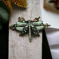 "The perfect accessory to complement your steampunk style is my Bronze Dragonfly Barrette! With its intricate design and stunning Swarovski crystals, this barrette will add a touch of glamour and whimsy to any outfit. Crafted from high-quality bronze, this barrette features a beautiful dragonfly with intricate detailing and sparkling Swarovski crystals. The unique steampunk design of this barrette is perfect for those who love vintage, industrial, and science fiction-inspired fashion. This barre Dragon Fly Hair Clip, Dragonfly Jewelry Necklace, Dragonfly Hair Clip, Steampunk Dragonfly, Gothic Hair, Beautiful Dragonfly, Gothic Hairstyles, Crystal Hair Clips, Style Steampunk