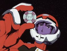 a man in an astronaut suit holding up a watch