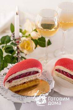 two pastries on a plate next to wine glasses