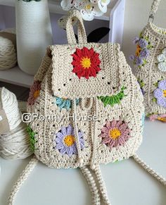 two crocheted purses sitting on top of a table