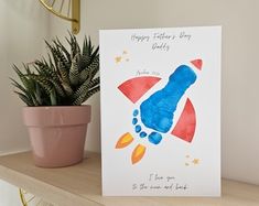 a card with an image of a rocket ship and the words happy father's day written on it