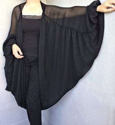 Black Sheer Long Sleeve Outerwear, Spring Black Sheer Outerwear, Black Summer Evening Outerwear, Black Shawl Kimono For Spring, Black One Size Open Front Kimono, Black Evening Kimono For Spring, Black Fall Party Kimono, Black Flowy Kimono With Kimono Sleeves, Chic Black Kimono For Party