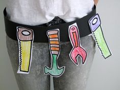 a person wearing a black belt with different colored objects on the waist and bottom of their pants