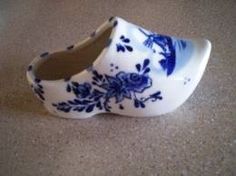 a blue and white shoe sitting on top of a floor