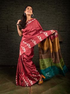 The USP of this saree is its aanchal. The multicolour aanchal is in contrast with the body of the saree. Its crimson red colour is contrasting which makes it alluring. Minimal discharge of leaf print makes it look beautiful. The floral pattern suggests that it is a nature-centric saree. Beautiful discharge printing on dark brick red colour makes it popular among saree lovers. Its multicolour  aanchal highlights the entire saree. So, it's a great example of how an exclusive block printing on pure gachi tussar silk saree from Bengal should be. WEIGHT: 450 gm COLOUR: Crimson Red CRAFT: Traditional Style of Hand Block printing DIMENSIONS: Saree length 6.5 Mts., Saree width 1.14 Mts. Blouse piece inclusive. MOTIF: Floral PRODUCT MATERIAL: Handwoven Gachi Tussar Silk saree WASH INSTRUCTIONS:  Dr Multicolor Handloom Tussar Silk Pre-draped Saree, Red Tussar Silk Pre-draped Saree For Festivals, Red Slub Silk Pre-draped Saree For Navratri, Red Cotton Silk Pre-draped Saree For Diwali, Red Cotton Silk Pre-draped Saree, Red Cotton Silk Pre-draped Saree With Cutdana, Festive Multicolor Pre-draped Slub Silk Saree, Red Slub Silk Pre-draped Saree With Cutdana, Red Raw Silk Pre-draped Saree With Self Design