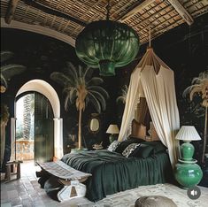 a bedroom with a canopy bed and palm trees on the wall