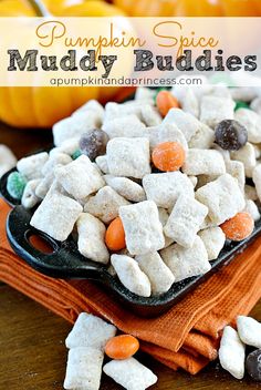 pumpkin spice muddy buddies in a cast iron skillet on top of a wooden table