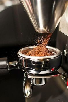 a coffee pot filled with ground coffee being poured into it