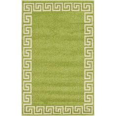 a green rug with white greek border