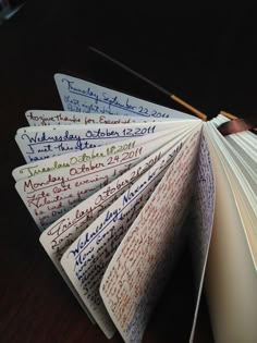 an open book with writing on it sitting on a table