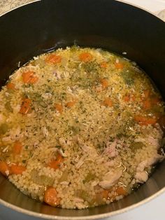 a pot filled with chicken and rice on top of a stove