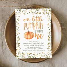 a little pumpkin is turning one birthday party card on a plate with twine sprinkles