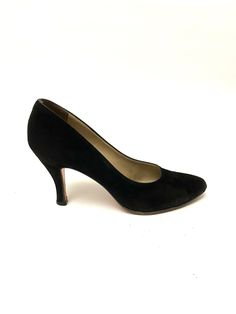 Vintage 1970s classic black suede pumps by Salvatore Ferragamo. Features black suede uppers, classic curvy construction, rounded toe, and cone heel. Excellent vintage condition with slight overall wear. Made in Italy. Heel to toe (inside shoe): 9.625 inches Ball of foot (bottom of sole): 2.875 inches Heel height: 3.5 inches Size 7 AA Classic Suede Heels, Classic Fitted Suede Court Shoes, Classic Fitted Suede Heels, Classic Closed Toe Suede Heels, Classic Suede Closed Toe Heels, Vintage Fitted Court Shoes With Padded Heel, Classic Closed Toe Heels With Suede Lining, Evening Suede Court Shoes With Round Toe, Fitted Suede Court Shoes With Round Toe