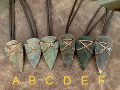 "These are modernly knapped arrowheads from jasper and are wire wrapped securely in raw, shiny copper. READY TO SHIP! Choose the arrowhead that calls to you from the dropdown at checkout. Each arrowhead ranges from 2\"-2.25\" approximately. Brown cowhide leather is a sustainable, natural material and is dyed with lead free vegetable dyes. Necklace is adjustable from approx 24\"-16\" and operates with a slide knot to slip over the head. All jewelry from my studio arrives attractively packaged and Wire Wrapped Arrowhead, Arrowheads Jewelry, Arrowheads Design, Wrapped Stones, Jewelry For Him, Arrowhead Pendant, Handmade Pendant Necklace, Arrowhead Necklace, Brown Cowhide