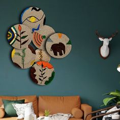 a living room filled with lots of furniture and wall art hanging on the side of it