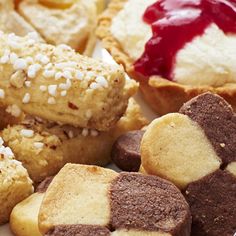 various pastries and desserts on a plate with confection spread around them