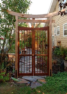 an open gate in front of a house