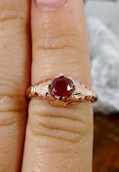 Natural Ruby Ring Description Floral Wedding Design#154 Custom This is a Victorian/Edwardian reproduction ring in 10k rose gold filigree with a natural red ruby gemstone solitaire. This full cut round cut red ruby gemstone is 4mm in diameter. The inside of the band is marked 10K for gold. Notice the beautiful floral design of the gold filigree setting. This is a lovely rendition of an Antique filigree ring, and it is ready to wear. A gift ring box is included and all rings are shipped in the rin Wedding Ruby Ring With Intricate Design, Rose Gold Filigree Wedding Jewelry, Rose Gold Filigree Jewelry For Wedding, Ruby Wedding Ring With Diamond Cut, Ornate 14k Gold Ruby Ring For Anniversary, Gold Filigree Ruby Wedding Ring, Heirloom Gold Ruby Ring For Wedding, Victorian Yellow Gold Ruby Ring For Wedding, Gold Ruby Ring With Filigree For Wedding